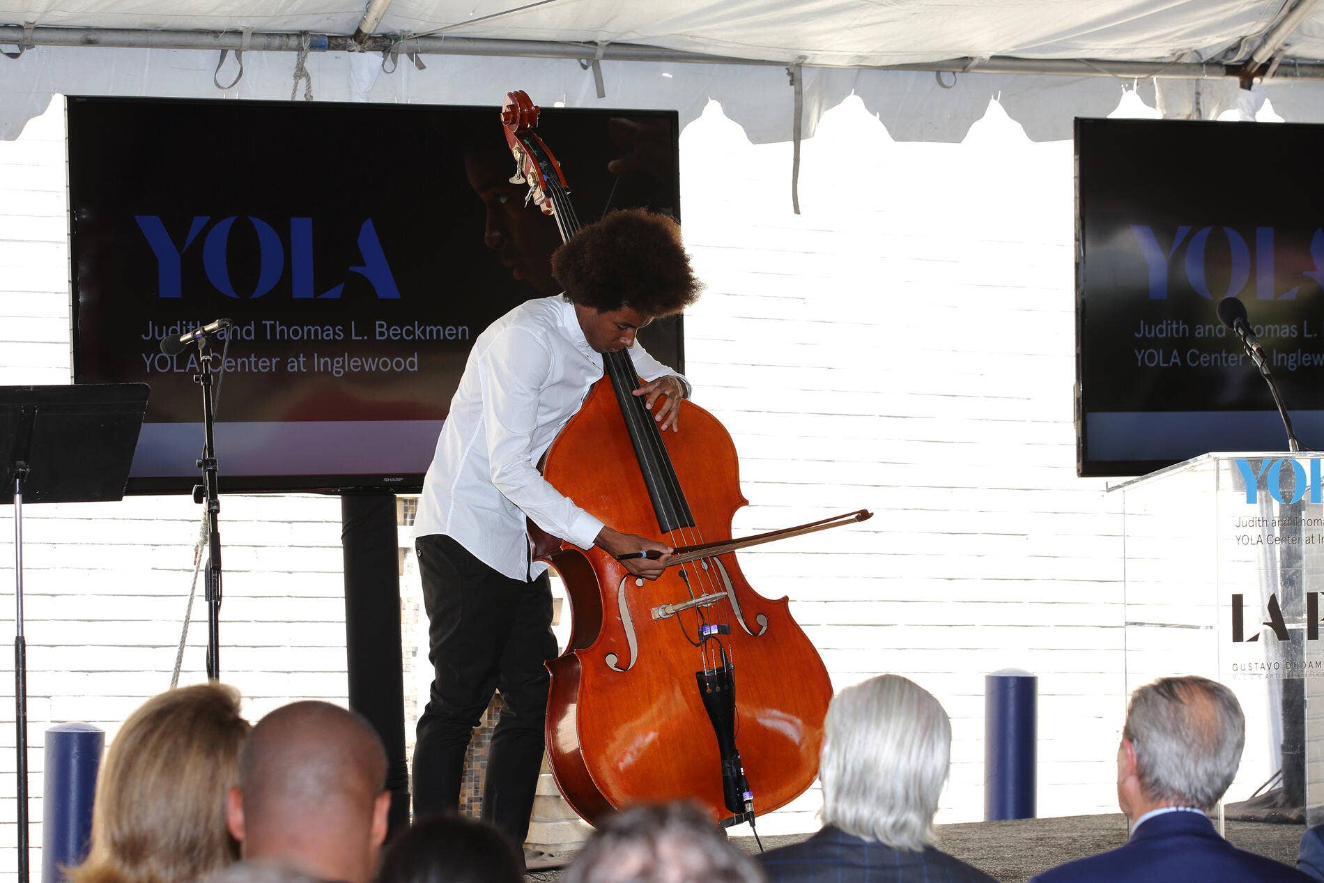 Moses Aubrey plays the standup bass during the grand opening event for the Beckmen YOLA Center.