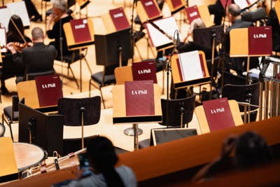 LA Phil stage with microphones, red music stands, and percussion instruments during a live performance rehearsal