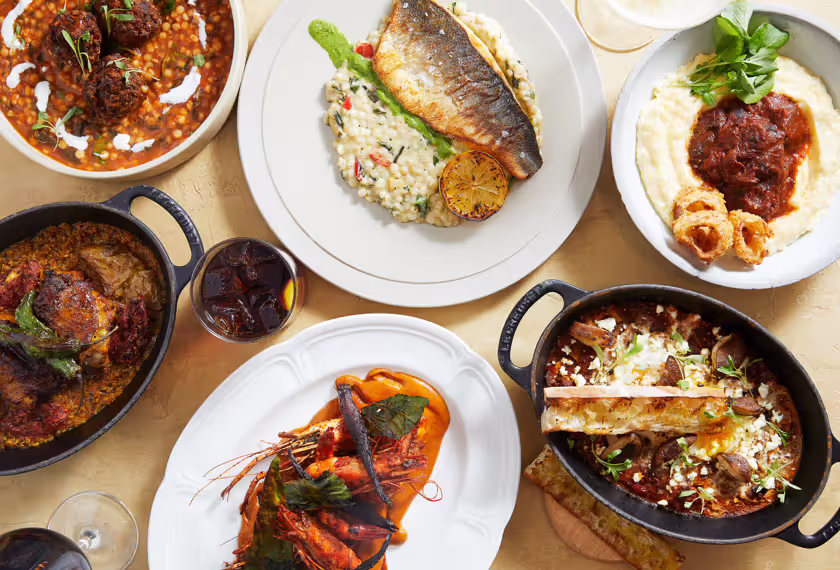 overhead view of salmon and other dishes on plates