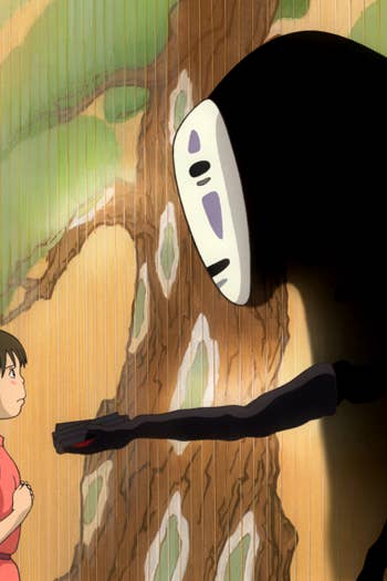Anime girl in a red hoodie confronts a giant black ghost-like figure with glowing white face in a hallway.