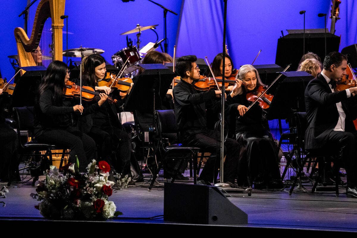 YOLA students perform with the the orchestra on stage at the Hollywood Bowl.