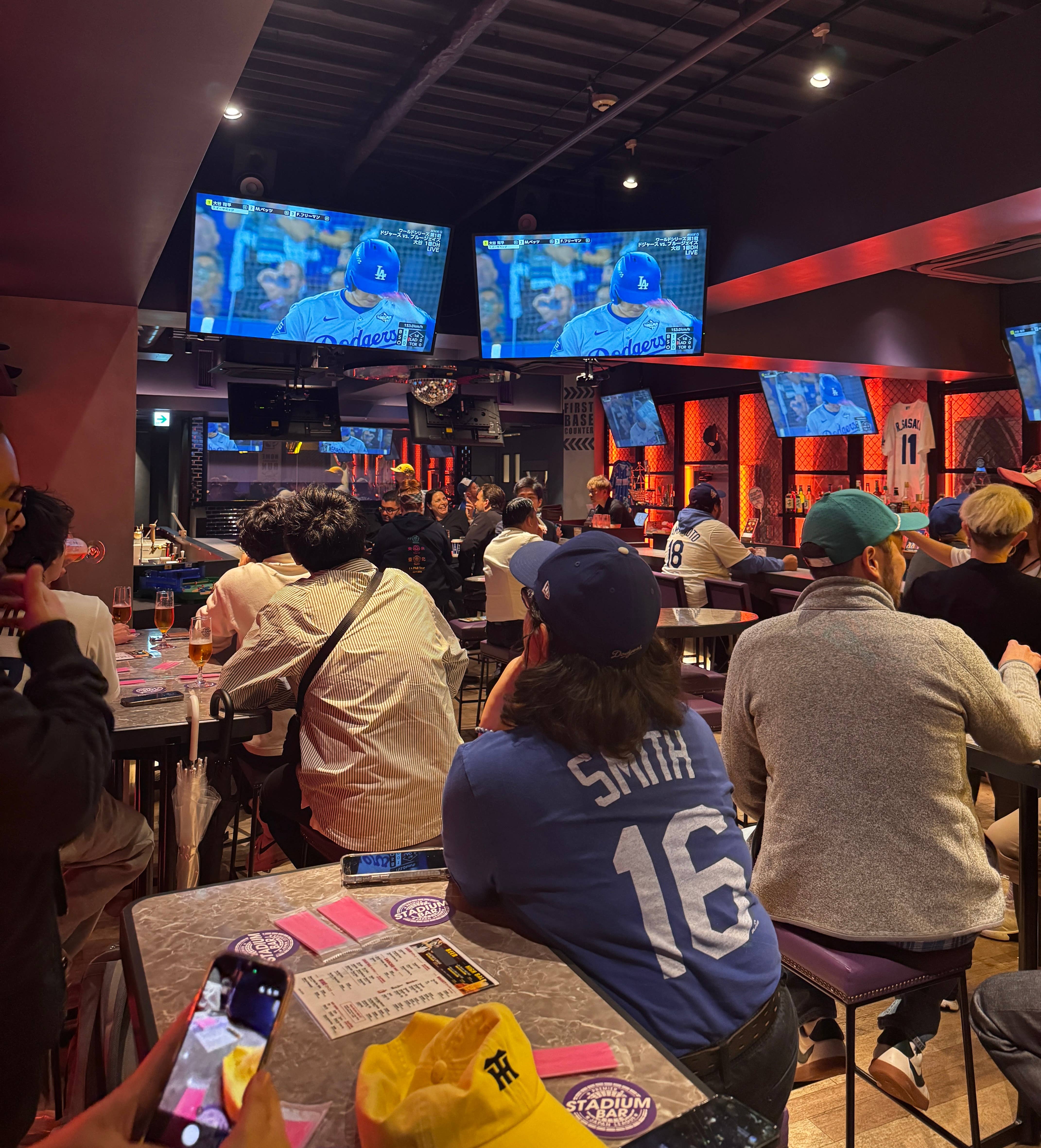 Members of the LA Phil cheer on the Dodgers at Tokyo’s Stadium Bar.