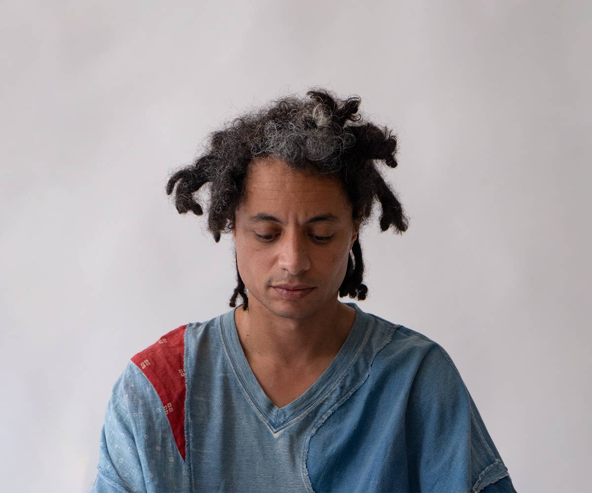 José James gazes downwards.
