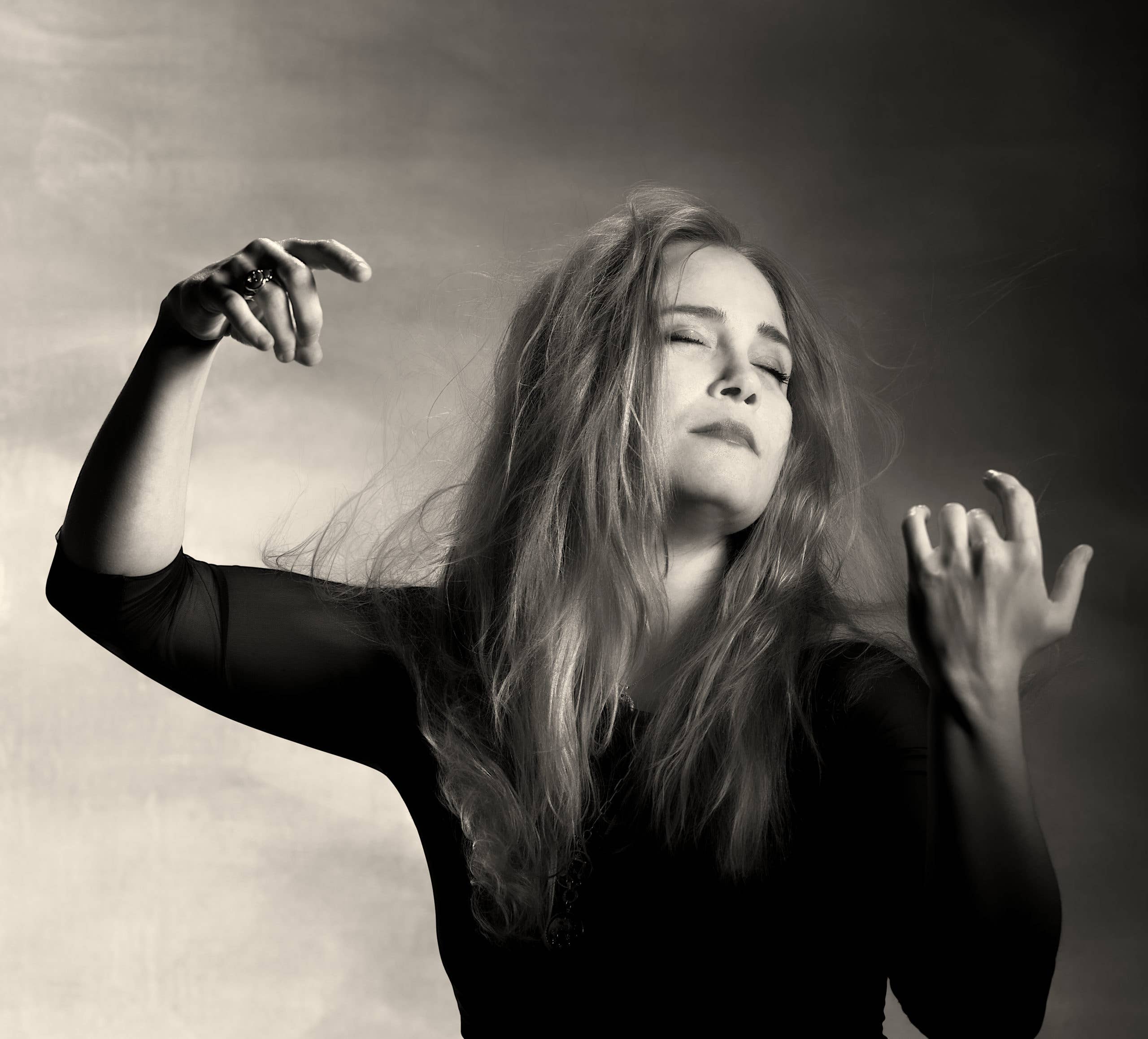 Black and white portrait of Leila Josefowicz wrapped up in emotion while playing an invisible violin.