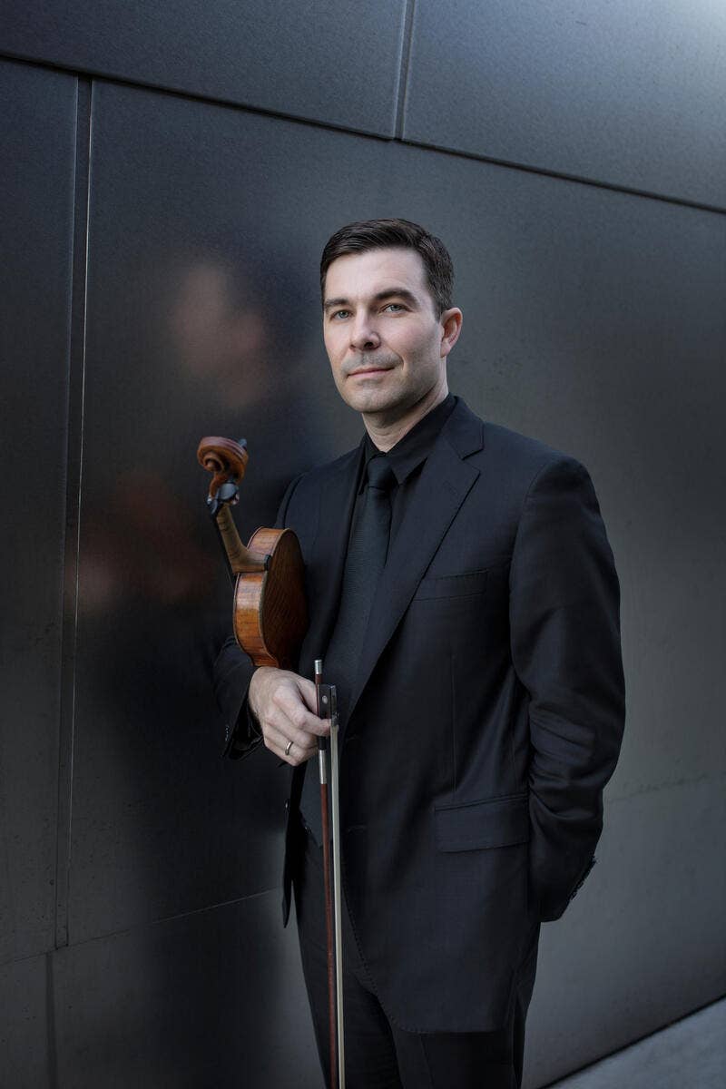 Nathan Cole holding a violin.