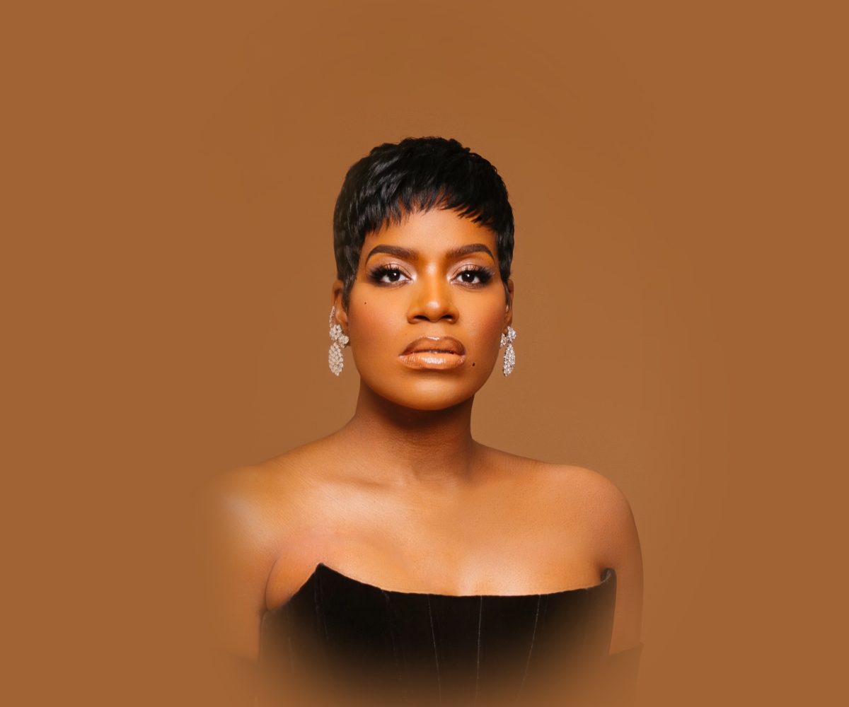 Fantasia, wearing a striped top, looks off into the distance. 