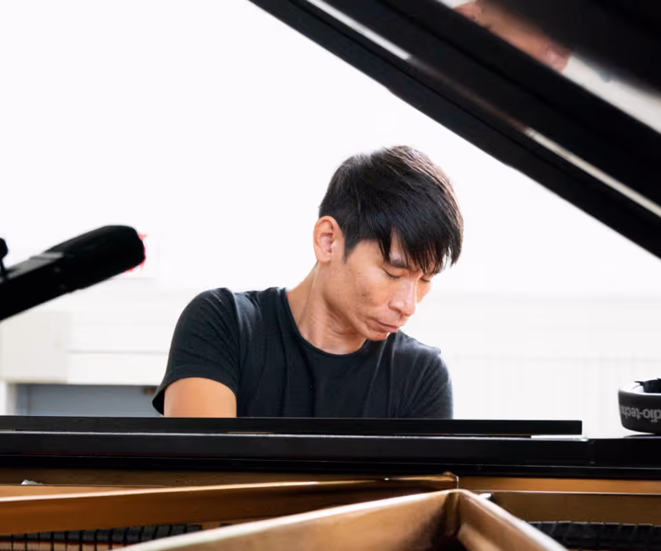 man playing the piano with eyes closed