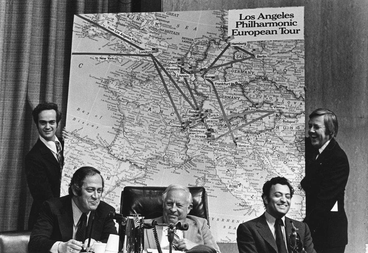 Los Angeles Philharmonic European Tour poster with musicians in suits posing around a map backdrop.