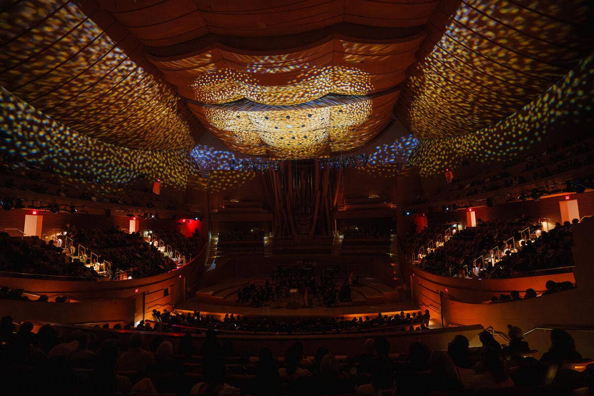 Dark interior of Walt Disney Concert hall with light projections on the ceiling