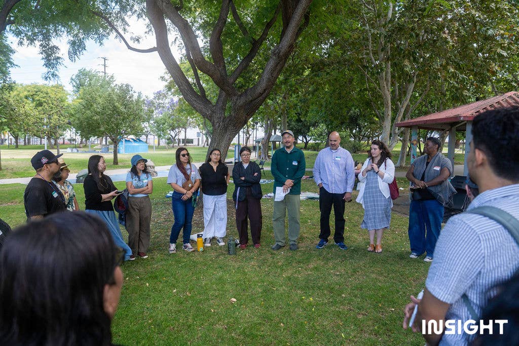 Audiences standing in a circle outdoors in Riverfront Park.