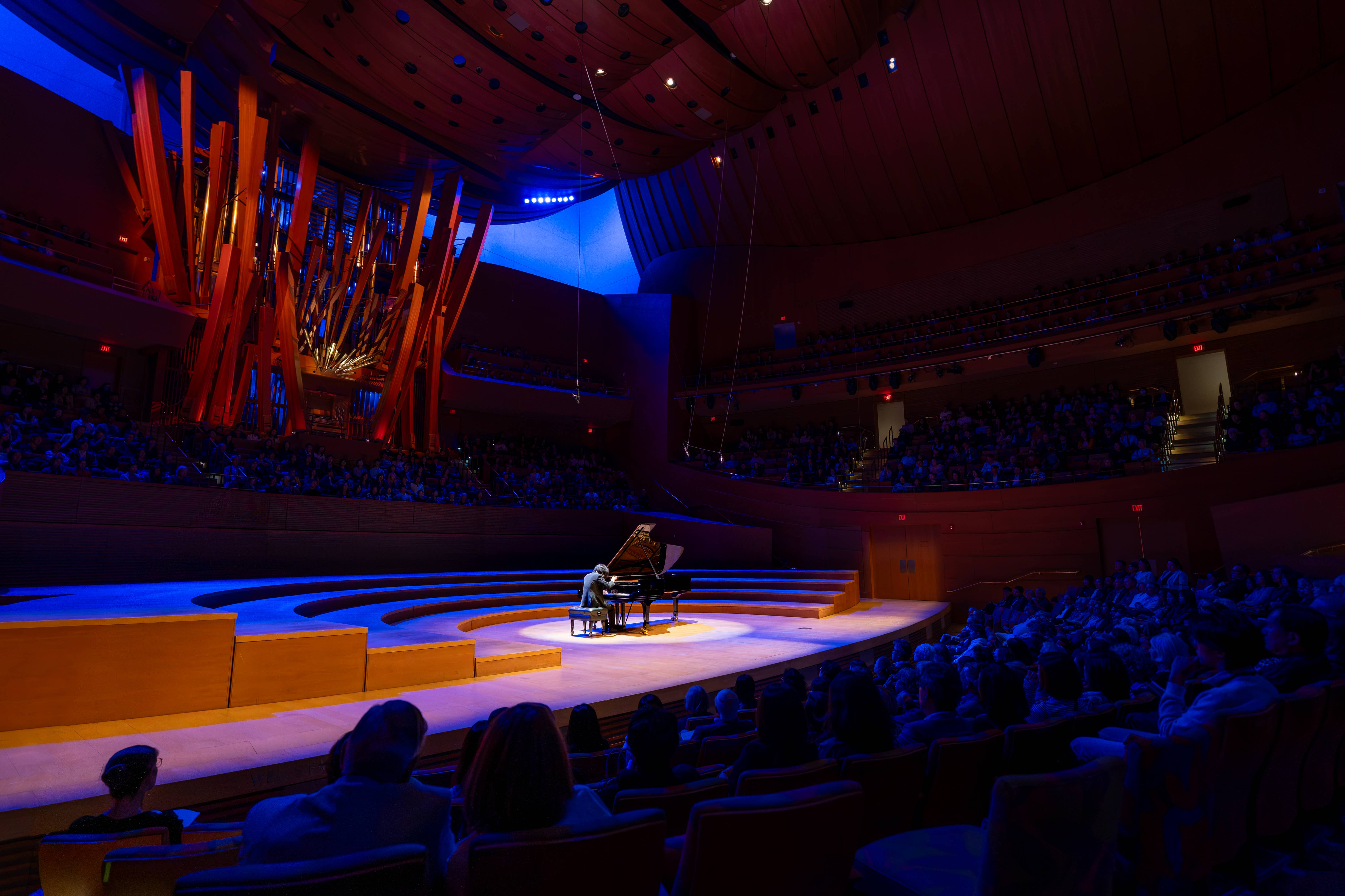 stage view of performer at piano during recital