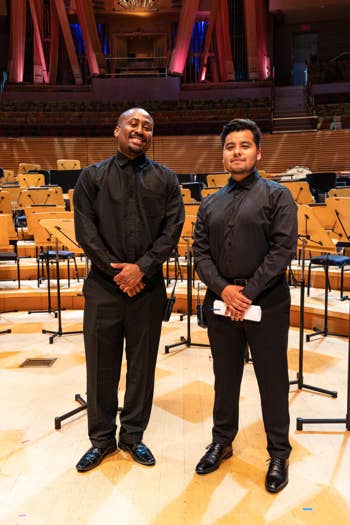Two IATSE Workforce Development Program Trainees stand on stage at the Walt Disney Concert Hall.