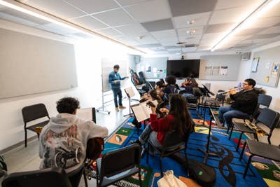YOLA students rehearse inside a classroom at the YOLA Inglewood campus.