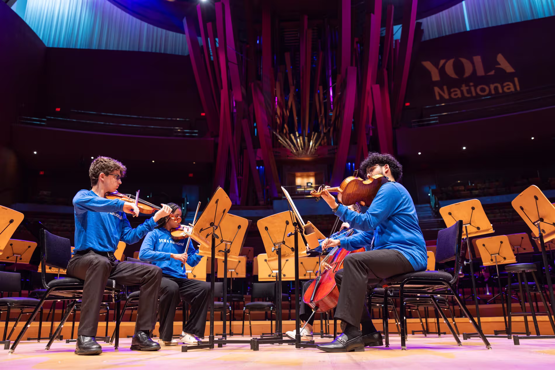 YOLA National students play violins during a performance on stage at the Walt Disney Concert Hall.