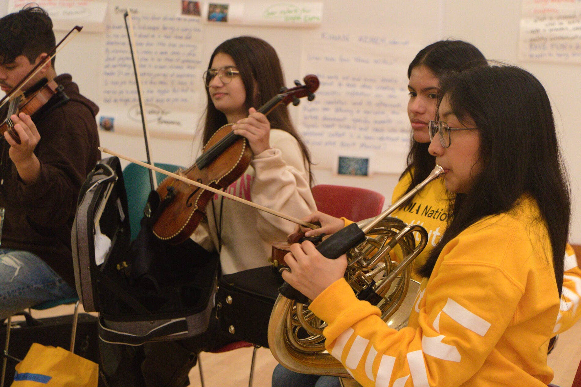 YOLA National Institute students play their instruments during rehearsal.