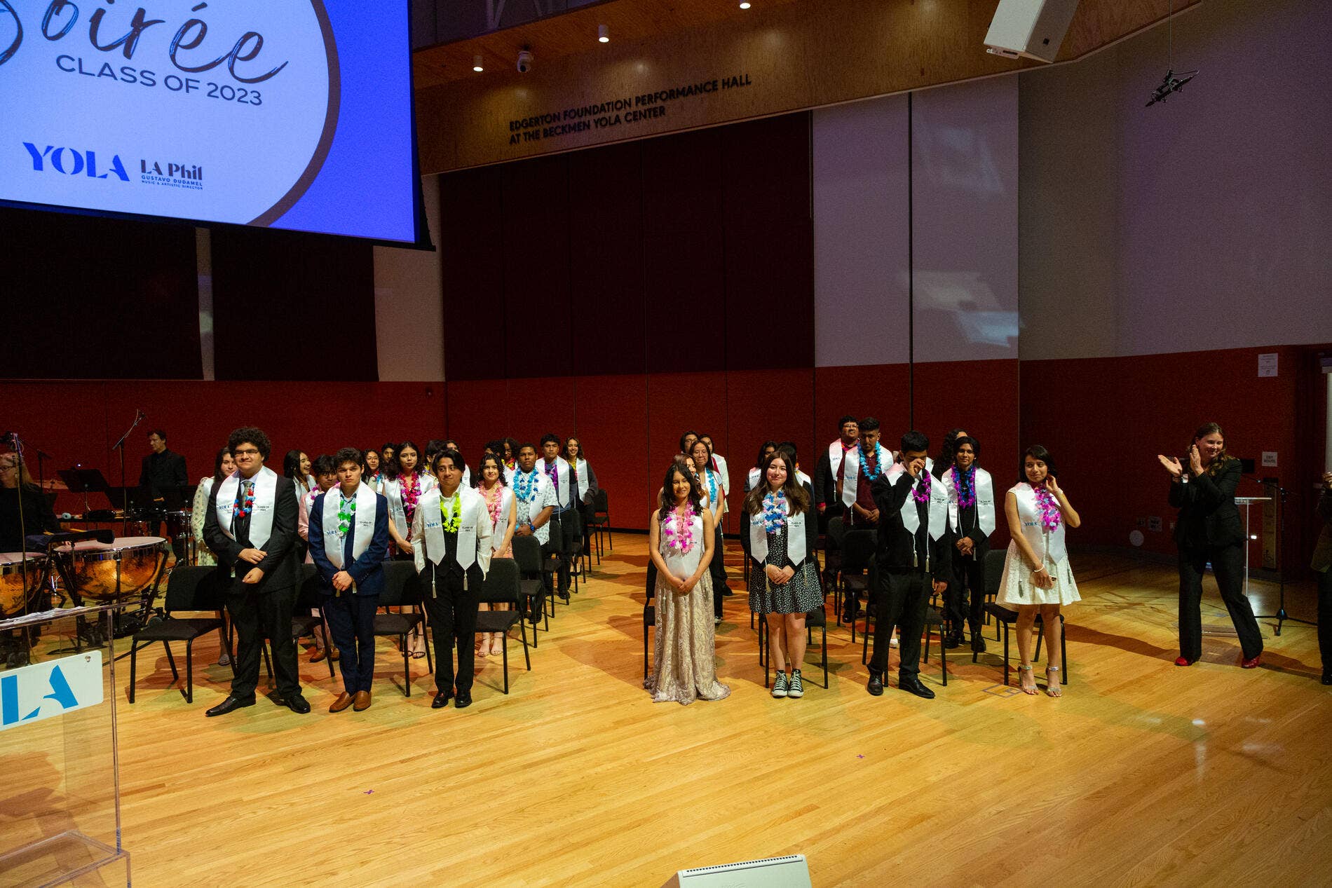 The 2023 YOLA graduating class stands during their graduation ceremony.