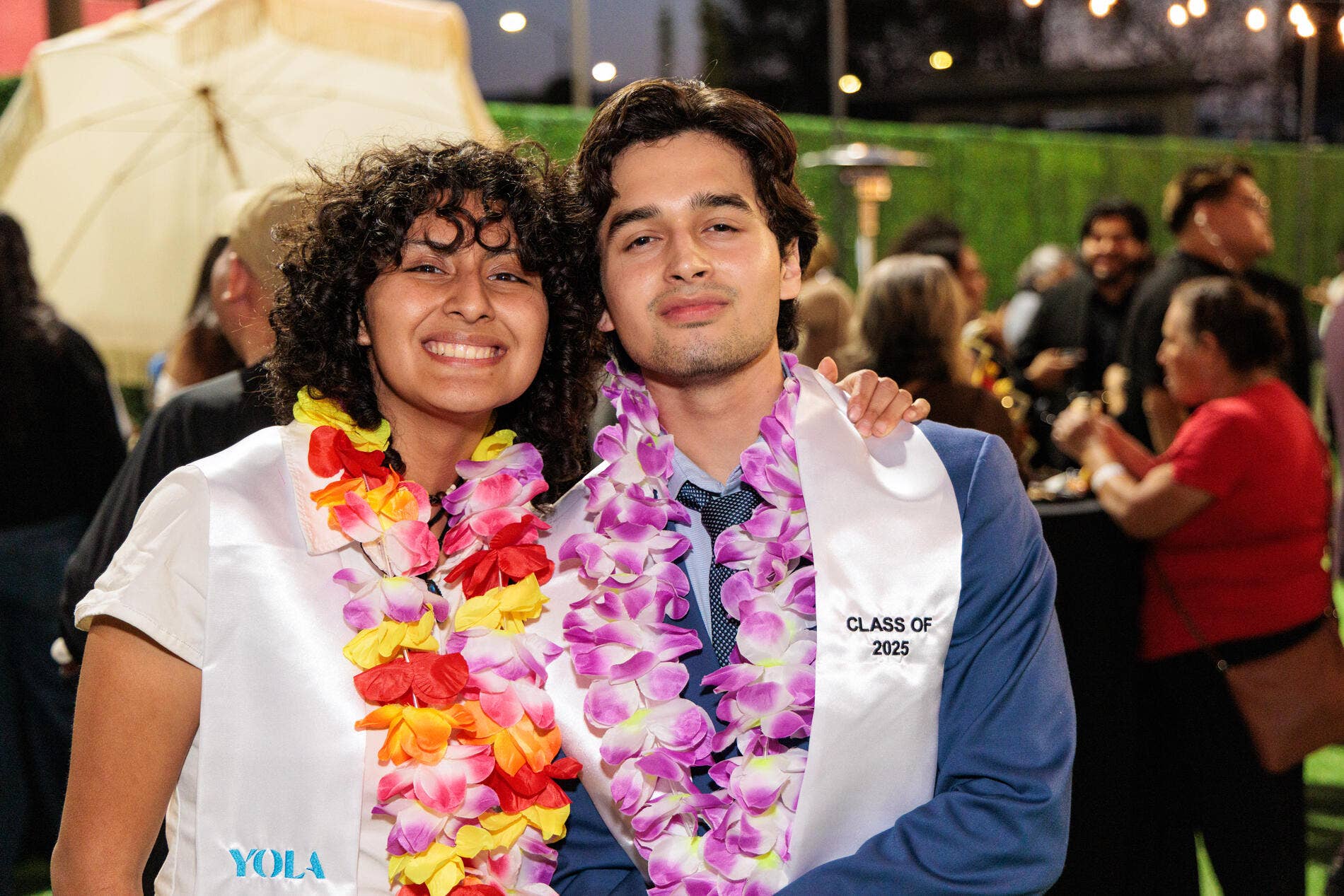 Two YOLA graduates pose together for a photo during the Soirée event.