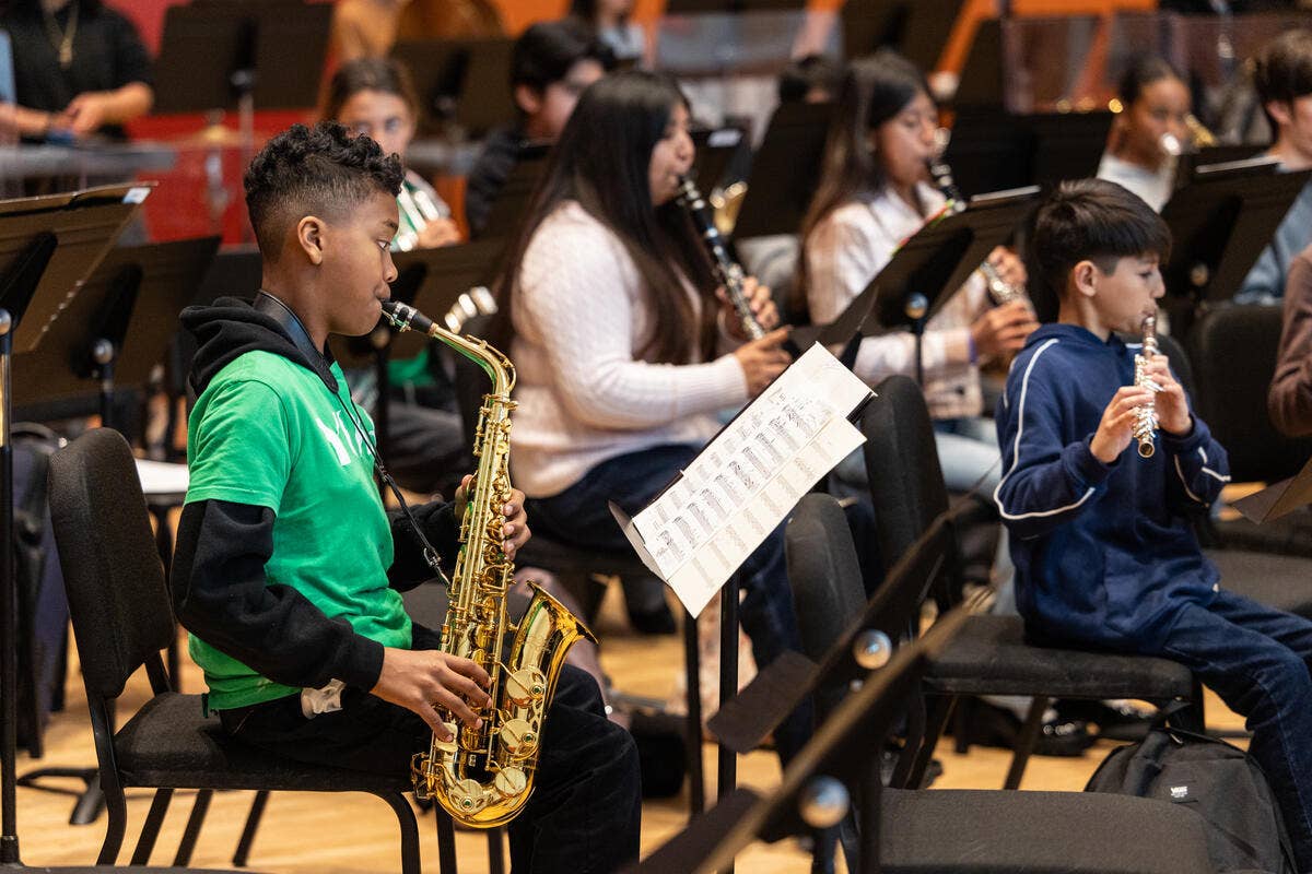 YOLA students play their instruments during rehearsal. 