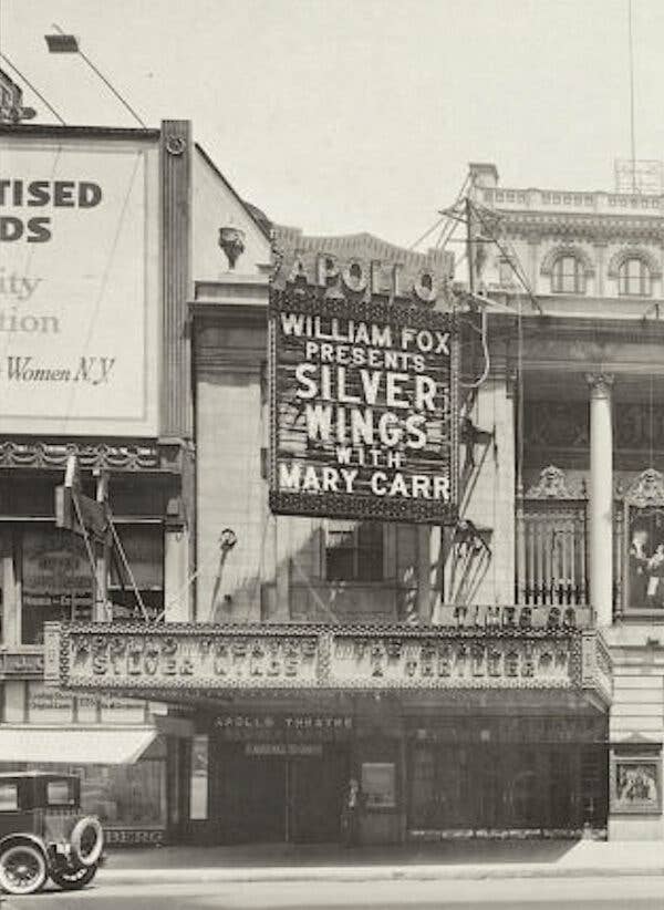 Apollo Theatre marquee with William Fox Presents Silver Wings with Mary Carr spelled out in lighted capital letters.