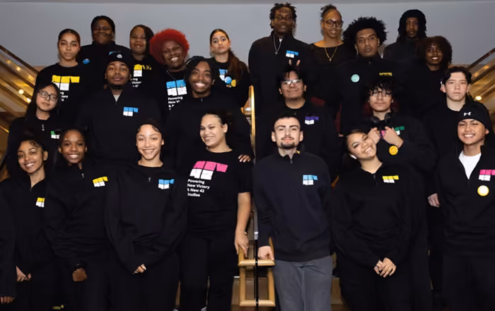A group of 23 ushers posing on stairs 