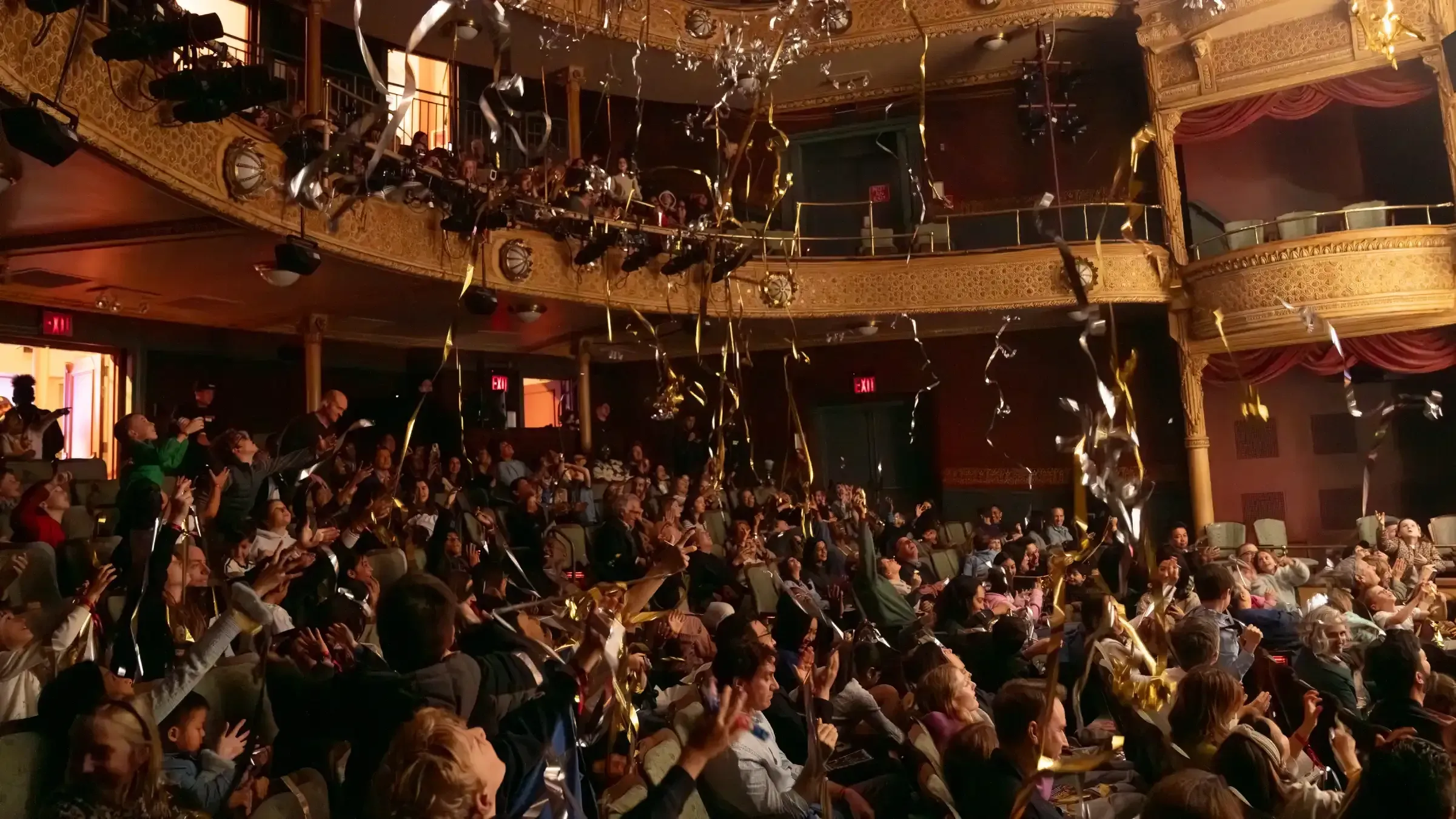 Shiny confetti falls on the audience in the New Victory Theater.