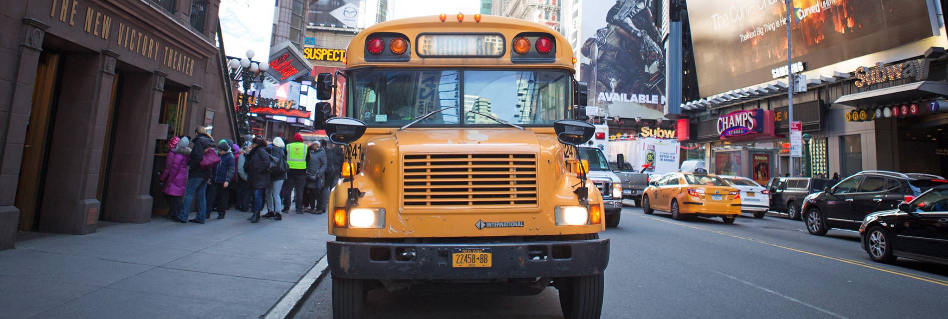 A school bus in front of the New Victory Theater