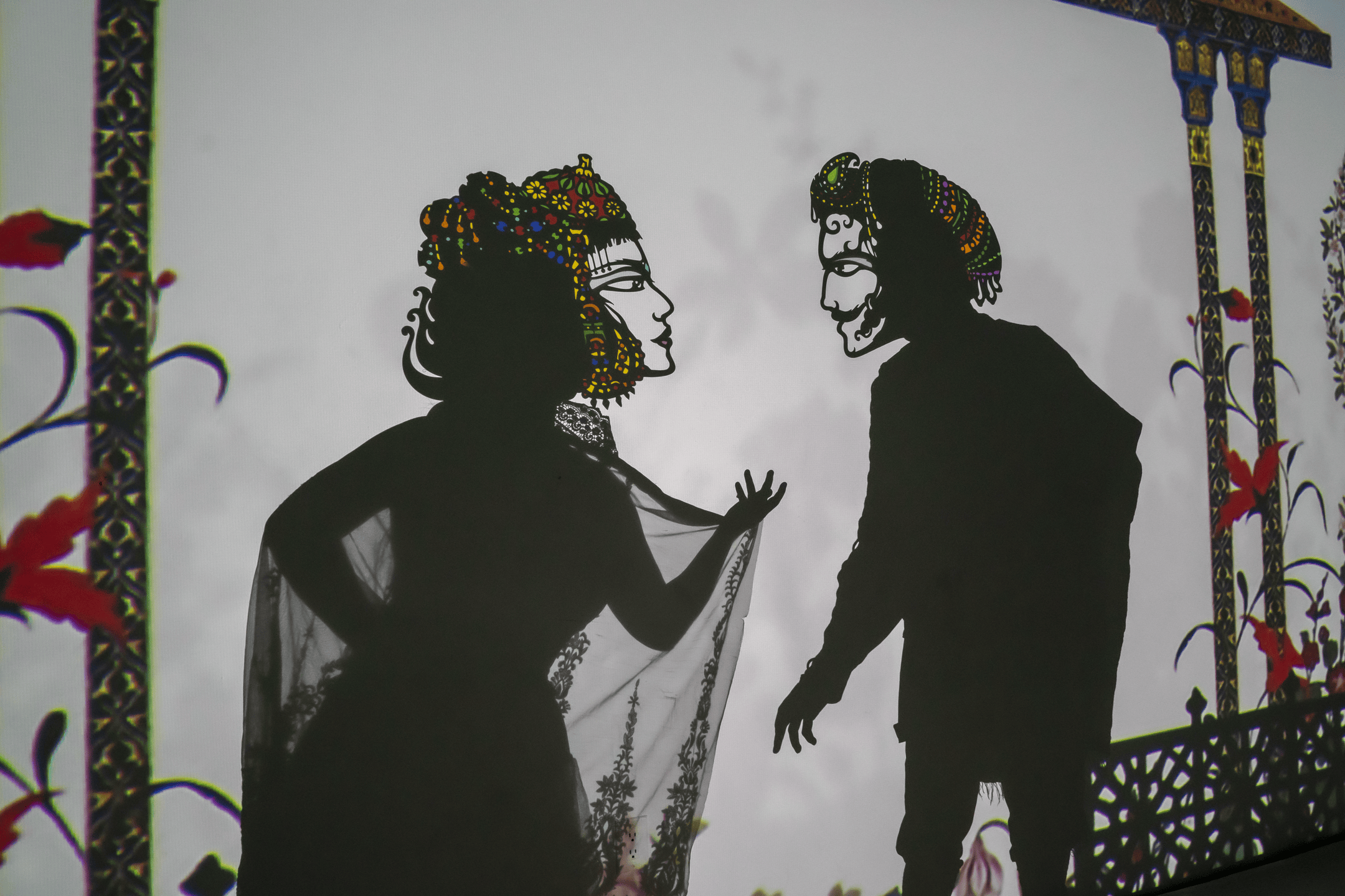 Two human-like shadow puppets talking