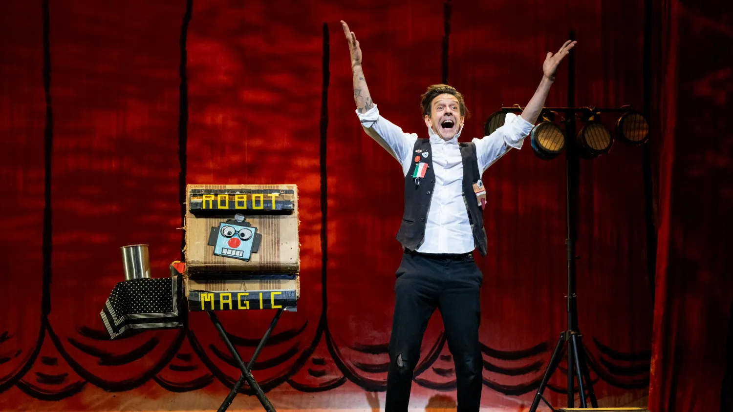 A man stands with his arms raised and makes an excited expression. Next to him, an open briefcase reads 