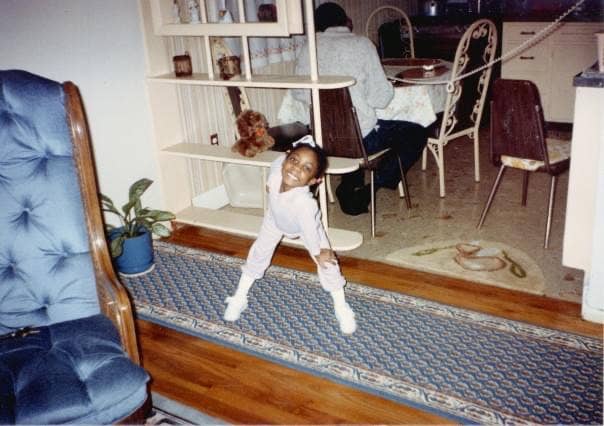 Olney Edmondson as a kid posing in her living room