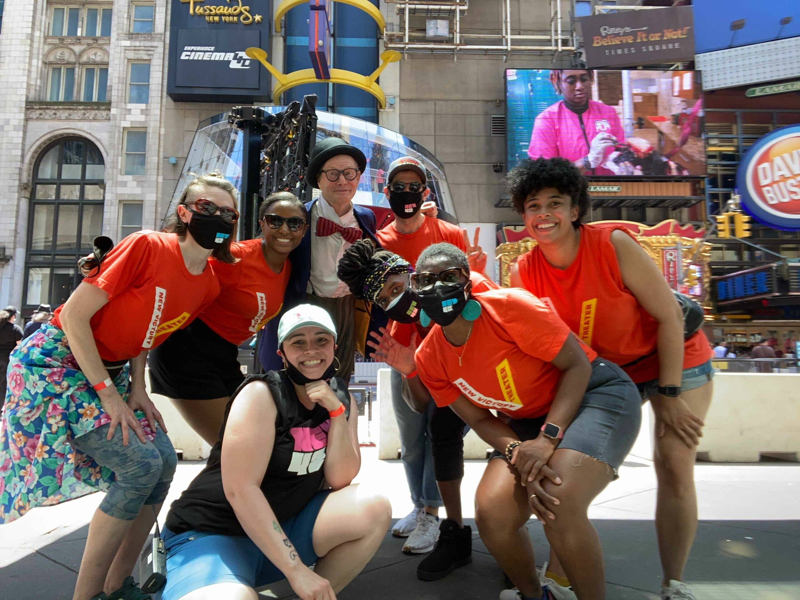 A group of New Victory Teaching Artists pose on 42nd Street.